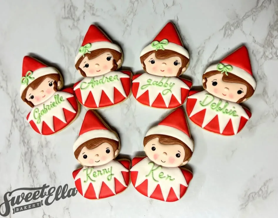 Christmas elf cookies, each iced with a name