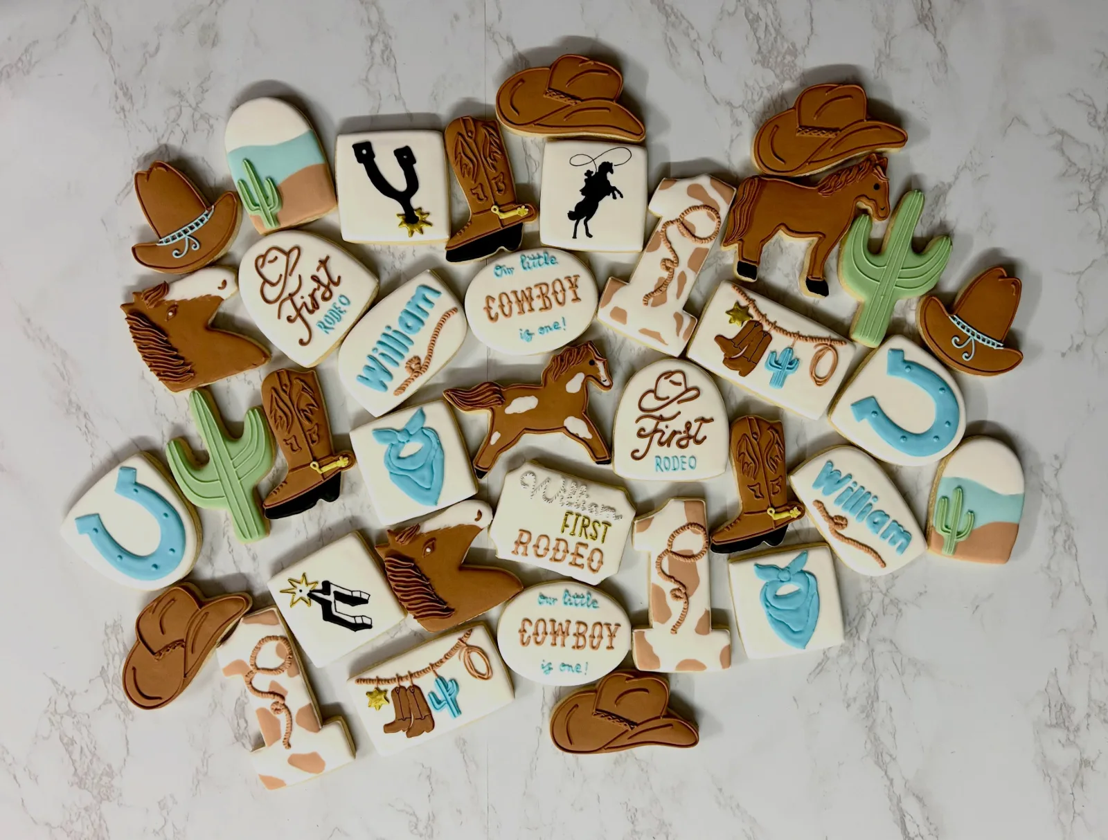 Cowboy boot, hat and horseshoe cookies for a first birthday