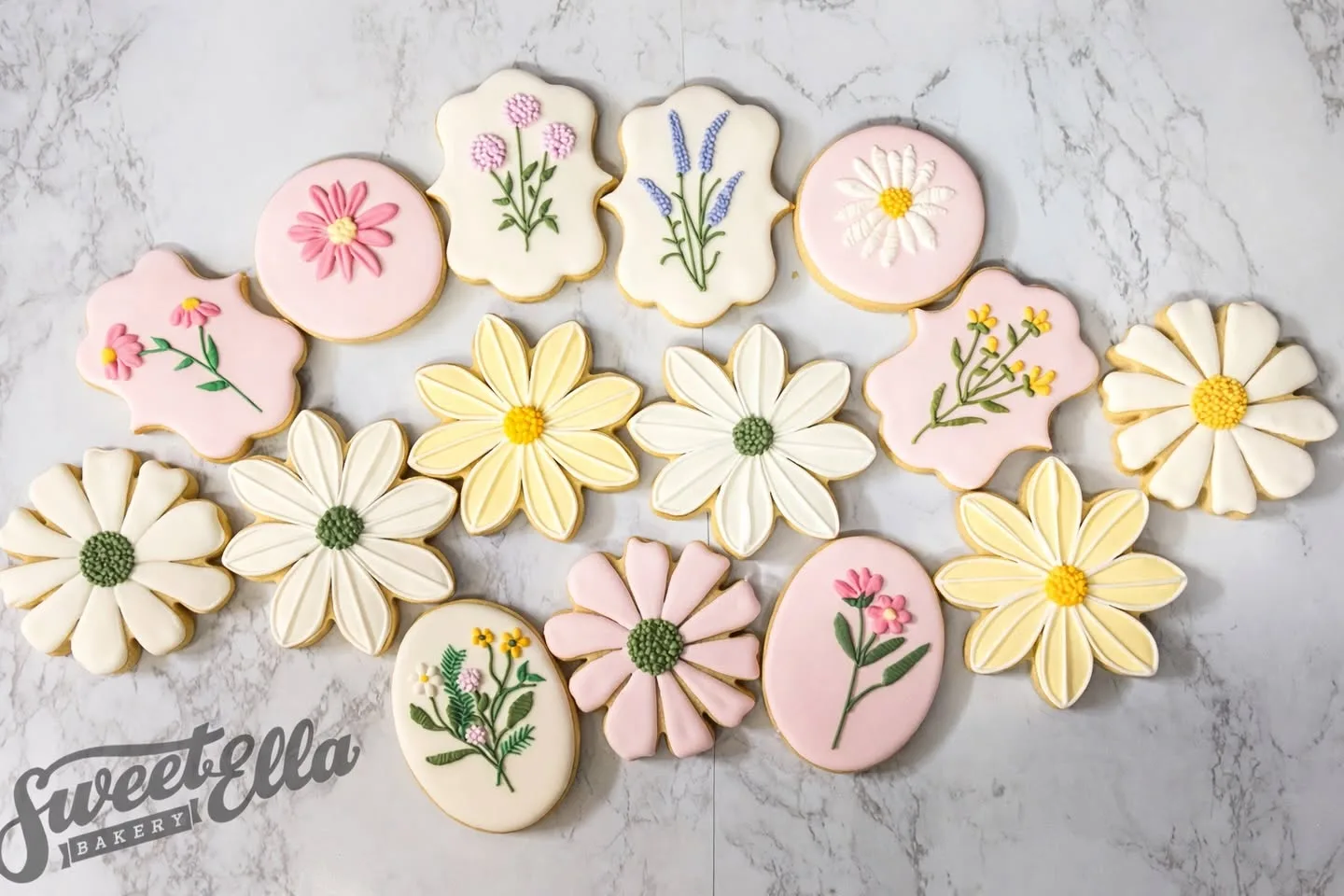 Pastel sugar cookies iced as daisies and wildflowers